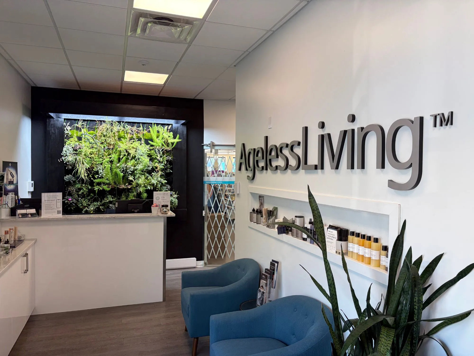 The Ageless Living reception, with its living plant wall and AgelessLiving sign