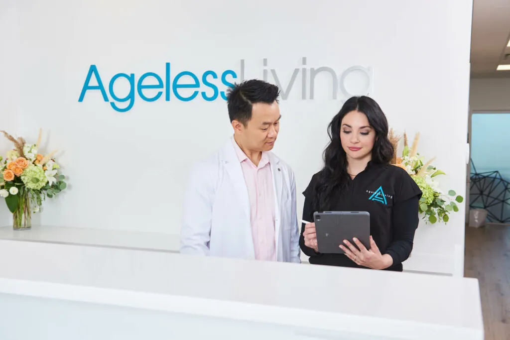 An Ageless Living physician and clinician reviewing a hormone protocol at the front desk