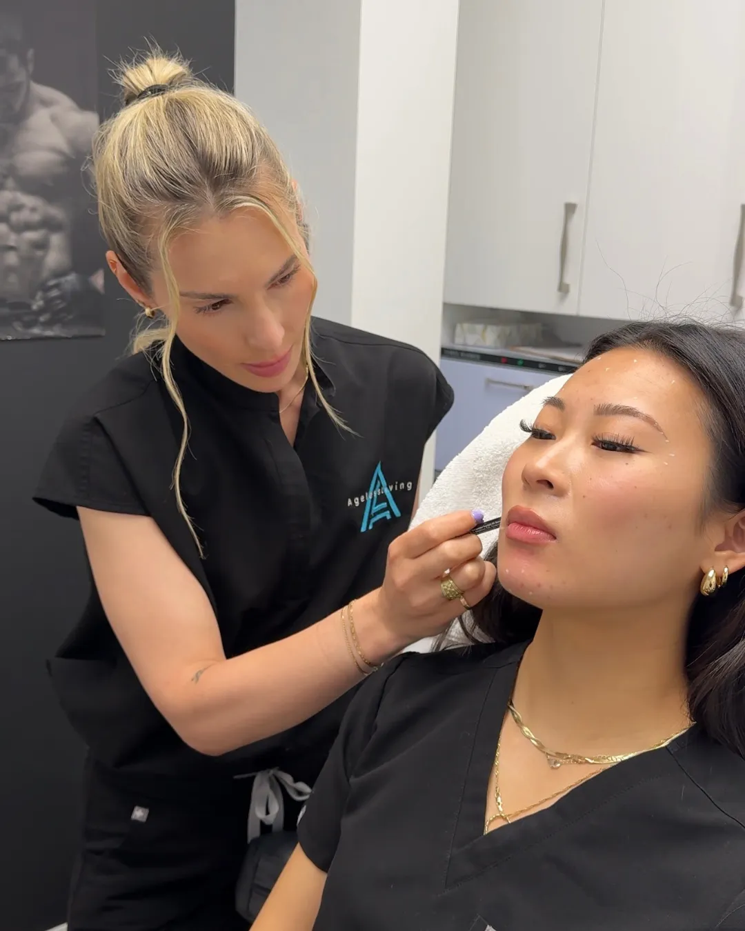 An Ageless Living practitioner mapping a patient’s face before an injectable treatment